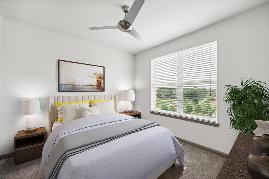 a bedroom with a large bed and a ceiling fan at Glenwood at Grant Park Apartments, Atlanta, Georgia